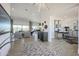 Open-concept living room with tile floors, neutral paint, modern lighting, and comfortable seating area at 7195 E Rancho Del Oro Dr, Scottsdale, AZ 85266