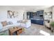 Living space with white couch, blue kitchen, and modern artwork at 7195 E Rancho Del Oro Dr, Scottsdale, AZ 85266