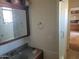 Bathroom featuring a large mirror, cabinet and single vanity sink at 7617 E Thunderbird Rd, Scottsdale, AZ 85260
