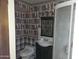 Bathroom featuring patterned wallpaper, sink, toilet, and standup shower at 7617 E Thunderbird Rd, Scottsdale, AZ 85260