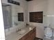 Bathroom featuring vanity and toilet with an insert for bathroom supplies at 7617 E Thunderbird Rd, Scottsdale, AZ 85260