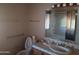 Bathroom featuring ceramic sink and shower with metallic fixtures at 7617 E Thunderbird Rd, Scottsdale, AZ 85260