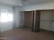 Bedroom with spacious closet and ceiling fan for climate control at 7617 E Thunderbird Rd, Scottsdale, AZ 85260