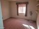 Bedroom featuring a window, carpet flooring, and ceiling fan at 7617 E Thunderbird Rd, Scottsdale, AZ 85260