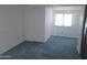 Bedroom featuring a window, light walls, and blue carpeting at 7617 E Thunderbird Rd, Scottsdale, AZ 85260