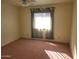 Bright bedroom featuring a window, carpet flooring, and ceiling fan at 7617 E Thunderbird Rd, Scottsdale, AZ 85260
