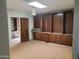 A bedroom featuring built-in storage cabinets and light hardwood floors at 7617 E Thunderbird Rd, Scottsdale, AZ 85260