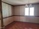 Bedroom with patterned wallpaper, tiled flooring, and bright window at 7617 E Thunderbird Rd, Scottsdale, AZ 85260