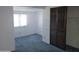 Bedroom featuring a window, light walls, and blue carpeting at 7617 E Thunderbird Rd, Scottsdale, AZ 85260
