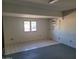 Bedroom featuring a window, neutral walls, and mixed flooring at 7617 E Thunderbird Rd, Scottsdale, AZ 85260