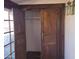 An empty wooden closet with vintage hardware and shelving at 7617 E Thunderbird Rd, Scottsdale, AZ 85260