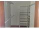 Walk-in closet featuring open shelving and rod for hanging at 7617 E Thunderbird Rd, Scottsdale, AZ 85260