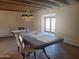 Dining room featuring a large table, chandelier, tiled flooring and French doors at 7617 E Thunderbird Rd, Scottsdale, AZ 85260