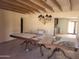 Dining room featuring a large table and unique ceiling beams at 7617 E Thunderbird Rd, Scottsdale, AZ 85260