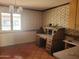 Home office with desk, lamp, floral wallpaper, and tiled flooring at 7617 E Thunderbird Rd, Scottsdale, AZ 85260