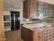 Spacious kitchen with custom cabinetry, stainless steel appliances and tile countertops at 7617 E Thunderbird Rd, Scottsdale, AZ 85260