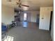 Spacious living room with ceiling fan and connected dining and kitchen area at 7617 E Thunderbird Rd, Scottsdale, AZ 85260