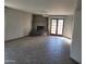 Bright living room featuring a brick fireplace, tiled flooring and French doors at 7617 E Thunderbird Rd, Scottsdale, AZ 85260