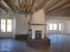 Spacious living room with windows, fireplace, tiled floors, and beamed ceilings at 7617 E Thunderbird Rd, Scottsdale, AZ 85260