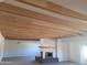 Living room with a beautiful fireplace and wood beamed ceiling at 7617 E Thunderbird Rd, Scottsdale, AZ 85260