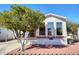 Charming mobile home with well-maintained front yard and mature tree providing ample shade at 7750 E Broadway Rd # 212, Mesa, AZ 85208