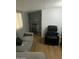 Neutral living room with hardwood floors, a gray couch, an entertainment center, and a black recliner chair at 7750 E Broadway Rd # 212, Mesa, AZ 85208