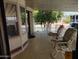 Covered porch features two rocking chairs and a nice view at 7750 E Broadway Rd # 212, Mesa, AZ 85208
