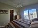 Comfortable bedroom features a ceiling fan, closet access, and private balcony access at 8700 E University Dr # 615, Mesa, AZ 85207