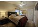 Comfortable main bedroom featuring a ceiling fan, natural light, and mirrored closet at 8700 E University Dr # 615, Mesa, AZ 85207