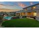 Lush backyard featuring a sparkling pool, well-manicured landscaping, and a covered patio for outdoor entertaining at 11036 E Evans Rd, Scottsdale, AZ 85255