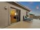 Private balcony featuring lounge seating and a sliding door entry into a well-appointed interior space at 11036 E Evans Rd, Scottsdale, AZ 85255
