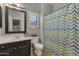 Charming bathroom with vanity, toilet, mirror and decorative chevron shower curtain at 11036 E Evans Rd, Scottsdale, AZ 85255