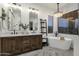 Bright bathroom featuring a soaking tub and stylish dual-sink vanity at 11036 E Evans Rd, Scottsdale, AZ 85255