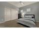 Bedroom with a bed, sliding closet doors, and two shuttered windows at 11036 E Evans Rd, Scottsdale, AZ 85255