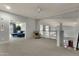 Inviting bonus room with cozy seating area, a ceiling fan, and seamless access to other living spaces at 11036 E Evans Rd, Scottsdale, AZ 85255