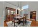 Formal dining room featuring a wooden table, chandelier, and display cabinet, perfect for entertaining at 11036 E Evans Rd, Scottsdale, AZ 85255