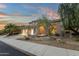 Elegant home exterior with three-car garage and manicured landscaping at 11036 E Evans Rd, Scottsdale, AZ 85255