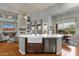Bright, open kitchen with stone accent wall in connected living room, dining area and stainless steel appliances at 11036 E Evans Rd, Scottsdale, AZ 85255