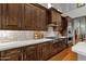 Gourmet kitchen featuring stainless steel appliances, hardwood floors, and stone backsplash at 11036 E Evans Rd, Scottsdale, AZ 85255