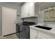 Well-organized laundry room with modern washer and dryer, white cabinets, and convenient countertop space at 11036 E Evans Rd, Scottsdale, AZ 85255