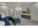 Stylish living room with a comfortable blue sectional, TV, and seamless access to other living spaces at 11036 E Evans Rd, Scottsdale, AZ 85255