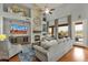 Spacious living room with a stone fireplace, large windows, and access to an outdoor patio at 11036 E Evans Rd, Scottsdale, AZ 85255