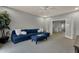 Stylish living room with comfortable blue sectional, seamless access to other living spaces and great natural light at 11036 E Evans Rd, Scottsdale, AZ 85255