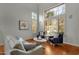 Bright living room featuring large windows, hardwood floors, and stylish furniture at 11036 E Evans Rd, Scottsdale, AZ 85255