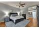 A spacious bedroom with a dark wood bed frame and a light-colored rug at 11036 E Evans Rd, Scottsdale, AZ 85255