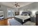 Spacious primary bedroom with king bed and pool views through French doors at 11036 E Evans Rd, Scottsdale, AZ 85255