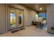 Inviting covered patio featuring comfortable seating, an illuminated ceiling, and access to the home's interior at 11036 E Evans Rd, Scottsdale, AZ 85255
