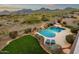 Beautiful backyard featuring a pool with rock waterfall feature and lush landscaping at 11036 E Evans Rd, Scottsdale, AZ 85255