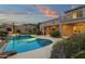 Inviting backyard pool and waterfall feature, nestled in lush landscaping, creates a private oasis for relaxation and recreation at 11036 E Evans Rd, Scottsdale, AZ 85255