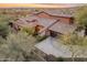 Elevated view of a terra cotta roof home with spacious driveway, mature trees, and neighborhood setting at 12035 W Red Hawk Dr, Peoria, AZ 85383